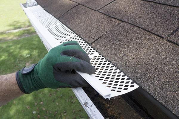 the installation of gutter guards typically involves fitting them over the existing gutters to provide a protective barrier